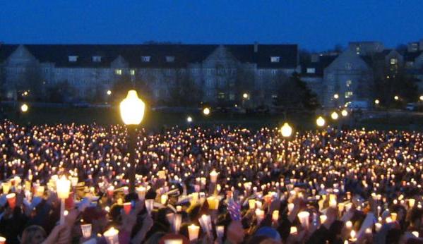 Mourners gather for a candlelight vigil after a school shooting.