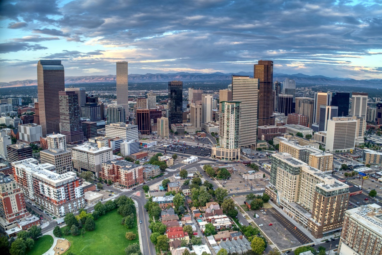 Aerial photo of the Denver cityscape with mountains in the background